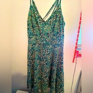 Green dress that has white flowers and orange flowers on it was made in China